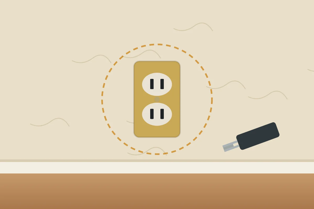 Illustration of an old two-prong outlet with a brass cover plate in a plaster wall